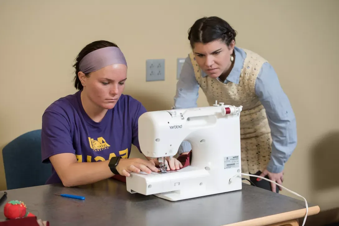 Fashion Merchandising student working at a sewing machine