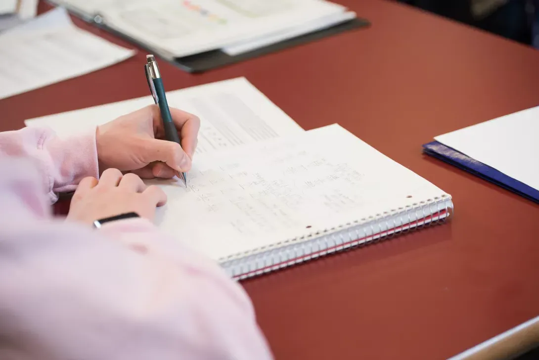 Accounting student writing in notebook